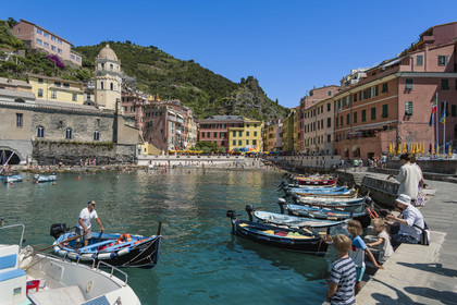 Italy, Liguria, Cinque Terre National Park listed as World Heritage by UNESCO, village of Vernazza, boats in the harbor