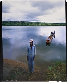 Burundi, Kirundo Province, Hutu man by the lake Cyohoha South also called Cohoha lake, in the background a carved canoe in a single trunk that can cross the lake to join the Rwanda (4x5 reversal film reproduction)