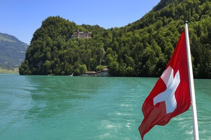 Switzerland, Canton of Bern, Bernese Oberland, Interlaken, Lake Brienz (Brienzer See), Luxury Hotel in Giessbach and swiss flag