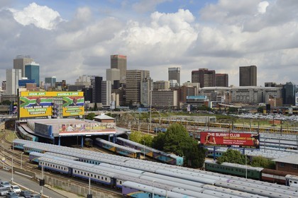South Africa, Gauteng Province, Johannesburg, train carriages at Park Station and Johannesburg CBD (Central Business District) seen from the district of Braamfontein