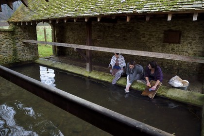 France, Eure, old wash-house of Sainte Colombe prés Vernon, Allied Reconstitution Group (US World War 2 and french Maquis historical reconstruction Association), the reenactors showing three women washing clothes in the washhouse in the 1940s