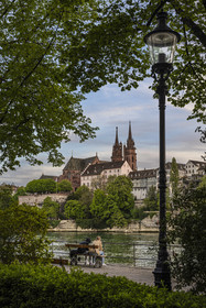 Switzerland, Canton Basel-Stadt, Basel, Little Basel district quays on the right bank of the river Rhine and the Minster or Protestant Cathedral of Our Lady of Basel (Munster) in the background