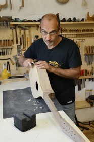 France, Haute Corse, Balagne, village of Pigna, the stringed-instrument maker Ugo Casalonga in his workshop making a cetera (cithern)
