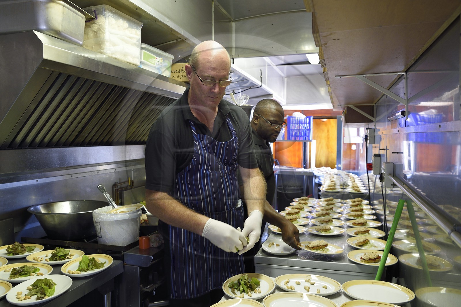 Namibia, Erongo region, the Shongololo express train, the two chefs in the narrow kitchen car