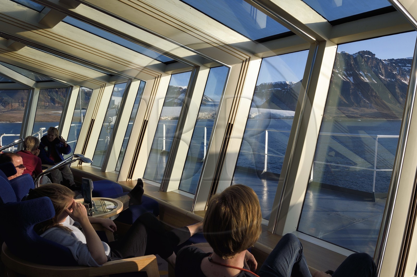 Greenland, North West coast, Murchison sound north of Baffin Bay, Hurtigruten's MS Fram cruise ship, passenger watching the Kissel Glacier on Kiatak (Northumberland Island) from the panoramic room