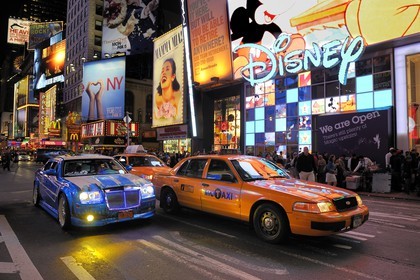 United States, New York, Manhattan, Theater district on Broadway Avenue, yellow cab in Times Square and customizeable car on parade