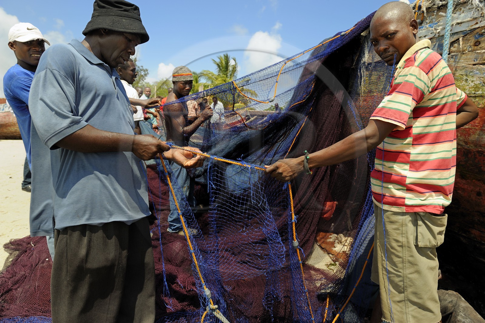 Tanzanie, Dar es-Salaam, intense activité de réparation de filets sur la plage desservant le marché aux poissons de Kivukoni