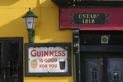 Republic of Ireland, County Kildare, Naas, old adverts on a pub 's wall