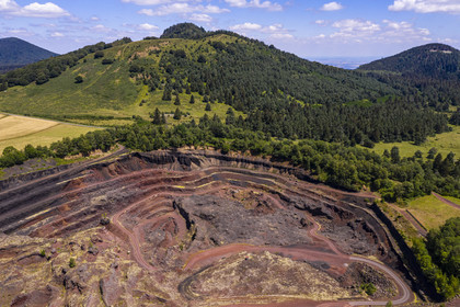 France, Puy de Dome, Parc Naturel Régional des Volcans d'Auvergne (regional nature park of Auvergne volcanoes), Chaine des Puys listed as World heritage by UNESCO, Saint Ours les Roches, Lemptegy volcano, a former pozzolan quarry that has become an educational site open to the public, the Puys Chopine and the Gouttes in the background (aerial view)