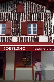 France, Pyrenees Atlantiques, Basque Country, Espelette, drying of Espelette peppers on the facades of village houses