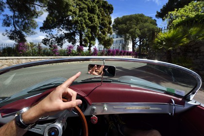 France, Alpes-Maritimes, Antibes, Cap d'Antibes, in the district of Eden Roc aboard a collection convertible Porsche Speedster 356, the villa Les Chênes Verts in the background
