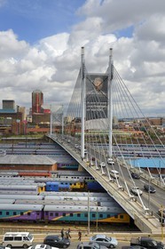 South Africa, Gauteng Province, Johannesburg, Nelson Mandela bridge over train carriages at Park Station and Johannesburg CBD (Central Business District) seen from the district of Braamfontein