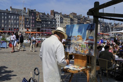 France, Calvados, Honfleur, the local painter Daniel Lallemand painting the Vieux-Bassin (Old Basin)