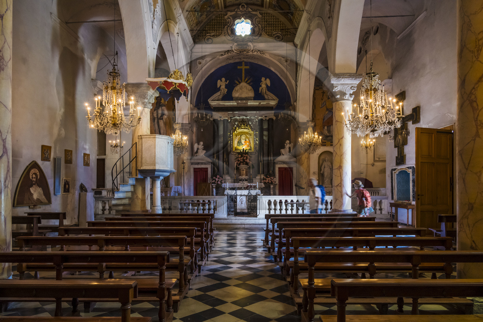 Italy, Liguria, Cinque Terre National Park listed as World Heritage by UNESCO, hikers in the church of the sanctuary of Nostra Signora di Reggio on the heights of the village of Vernazza Italy, Liguria, Cinque Terre National Park listed as World Heritage by UNESCO, hikers in the church of the sanctuary of Nostra Signora di Reggio on the heights of the village of Vernazza