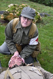 France, Eure, Sainte Colombe prés Vernon, Allied Reconstitution Group (US World War 2 and french Maquis historical reconstruction Association), the reenactor Nathalie Menager as a nurse from the 101st US Airborne Division caring for a wounded soldier