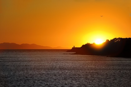 Italy, Tuscany, the Island of Elba at sunset and the coast at Piombino in the foreground