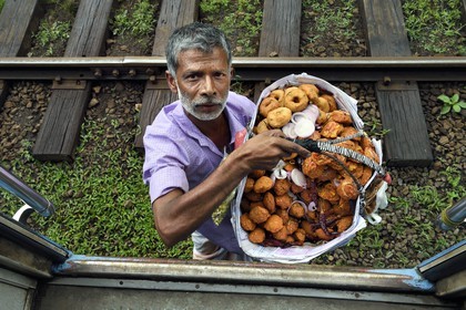 Sri Lanka, Central Province, the popular scenic train ride through the tea growing hill country between Hatton and Ella, Talawakele railway train station, fried shrimps and wade street vendor