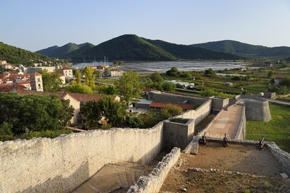 Croatia, Dalmatia, peninsula of Peljesac, the old town of Ston, the ramparts, the Saint-Nicolas monastery on the left and the salt marshes in the background