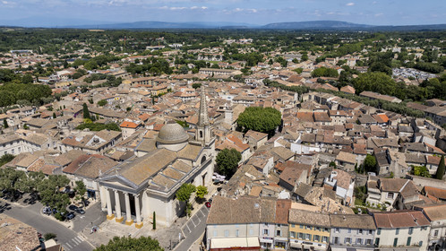 France, Bouches du Rhone, Regional Natural Park of the Alpilles, Saint Remy de Provence, Saint Martin church in the foreground (aerial view)