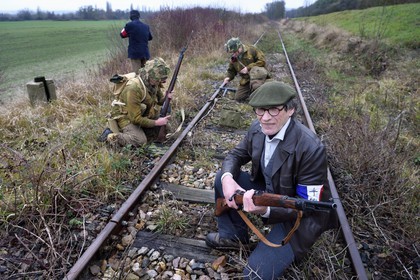 France, Eure, Cocherel, Allied Reconstitution Group (US World War 2 and french Maquis historical reconstruction Association), reenactors playing the role of British soldiers preparing to sabotage a railroad track using a plastic explosive loaf under the vigilance of partisans of the French Forces Interior (FFI)