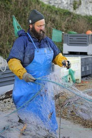 France, Seine-Maritime, Veules-les-Roses, fisherman retrieving the catch of the day of the nets