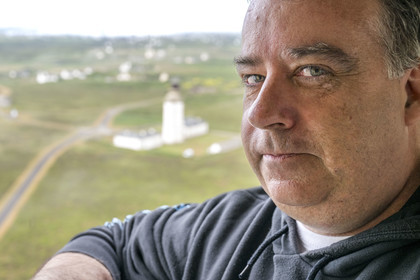 France, Finistère, Iroise Sea, Ouessant Island, Stiff radar tower by architect Jean Prouvé (1982) which monitors the maritime traffic rail in the Channel for the Cross Corsen, Patrick Cornic, CROSS technician in post since 2014, the Stiff lighthouse in the background