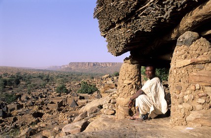 Mali, Dogon Country, village of Tereli, a man sitting under the Toguna (talking hut) overlooking the Bandiagara Cliff, listed as World Heritage by UNESCO