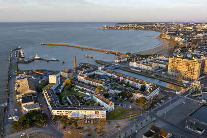 France, Loire-Atlantique, Saint-Nazaire, the Petit Maroc district in the foreground, the crab claw (nickname given to the southern entrance to the harbor basin by the two jetties) and the beach (aerial view)
