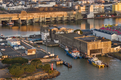 France, Loire Atlantique, Saint Nazaire, the former German submarine base built during the last world war border the dock of the harbour basin of Saint-Nazaire, the East lock and the fortified lock in the foreground on the right (aerial view)