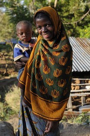 Tanzania, Morogoro district, Uluguru mountains, young girl carrying a child in a village around the former german refuge called Morningside