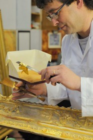 France, Yvelines, Chateau de Versailles, the castle restoration workshop, gilt workshop, Laurent Hissier working on a frame