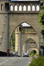 France, Indre et Loire, Loire Valley listed as World Heritage by UNESCO, Langeais, cyclists crossing suspension bridge over Loire River