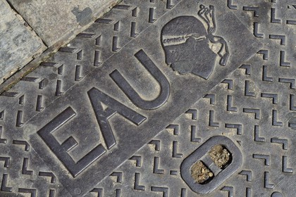 France, Haute Corse, Calvi, plate of the water network marked with the Moor's head emblem of Corsica