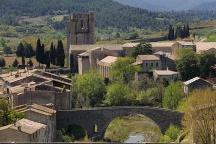 France, Aude, Lagrasse village, labelled Les Plus Beaux Villages de France (The Most Beautiful Villages of France), bridge over Orbieu River and Sainte Marie de Lagrasse Abbey in the background