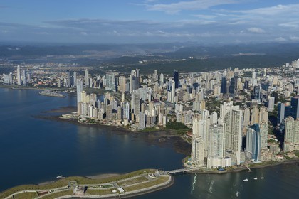 Panama, Panama City, the waterfront and skyscrapers, Colon point and the Trump tower right, the Panama Canal in background (aerial view)