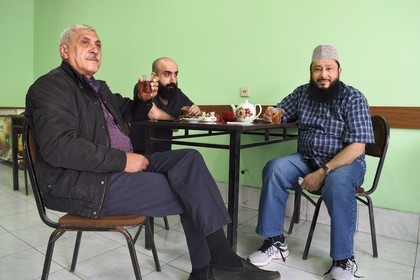 Azerbaijan, Quba (Guba) region, three men sharing a tea in a cafe
