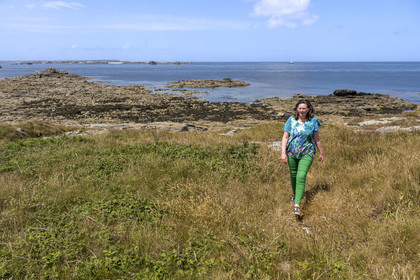 France, Finistère, Iroise Sea, Molene Island, Christine Demeure who manages the only grocery store on the island during her daily walk on the wild west coast
