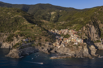 Italy, Liguria, Cinque Terre National Park listed as World Heritage by UNESCO, village of Manarola and its harbour (aerial view)