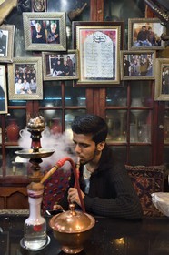 Iran, Isfahan Province, Isfahan, Chai Khaneh Azadegan Tea House and restaurant, man smoking a water pipe
