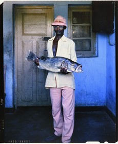 Burundi, Rumonge Province, young Hutu fisher who shows a Capitaine likely a Nile perch (Lates niloticus) (4x5 reversal film reproduction)