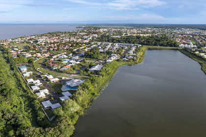 France, French Guiana, Kourou, the city is on the edge of wetlands, forests and savannas protected within the space center and managed by the National Forestry Office (ONF), bois-diable Lake to the right (aerial view)