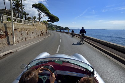 France, Alpes-Maritimes, Cannes, on the Boulevard Eugene Gazagnaire along the coast aboard a collection convertible Porsche Speedster 356