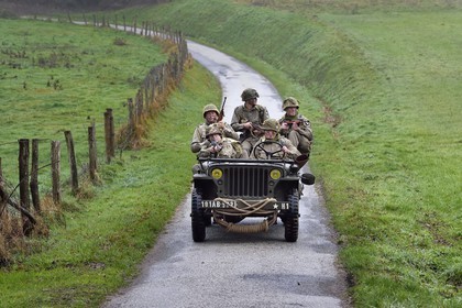 France, Eure, Sainte Colombe prés Vernon, Allied Reconstitution Group (US World War 2 and french Maquis historical reconstruction Association), reenactors in uniform of the 101st US Airborne Division progressing in a jeep Willys
