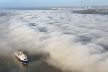 France, Seine Maritime, Le Havre, the port of Le Havre emerges from a sea of clouds, cruise ship in the foreground