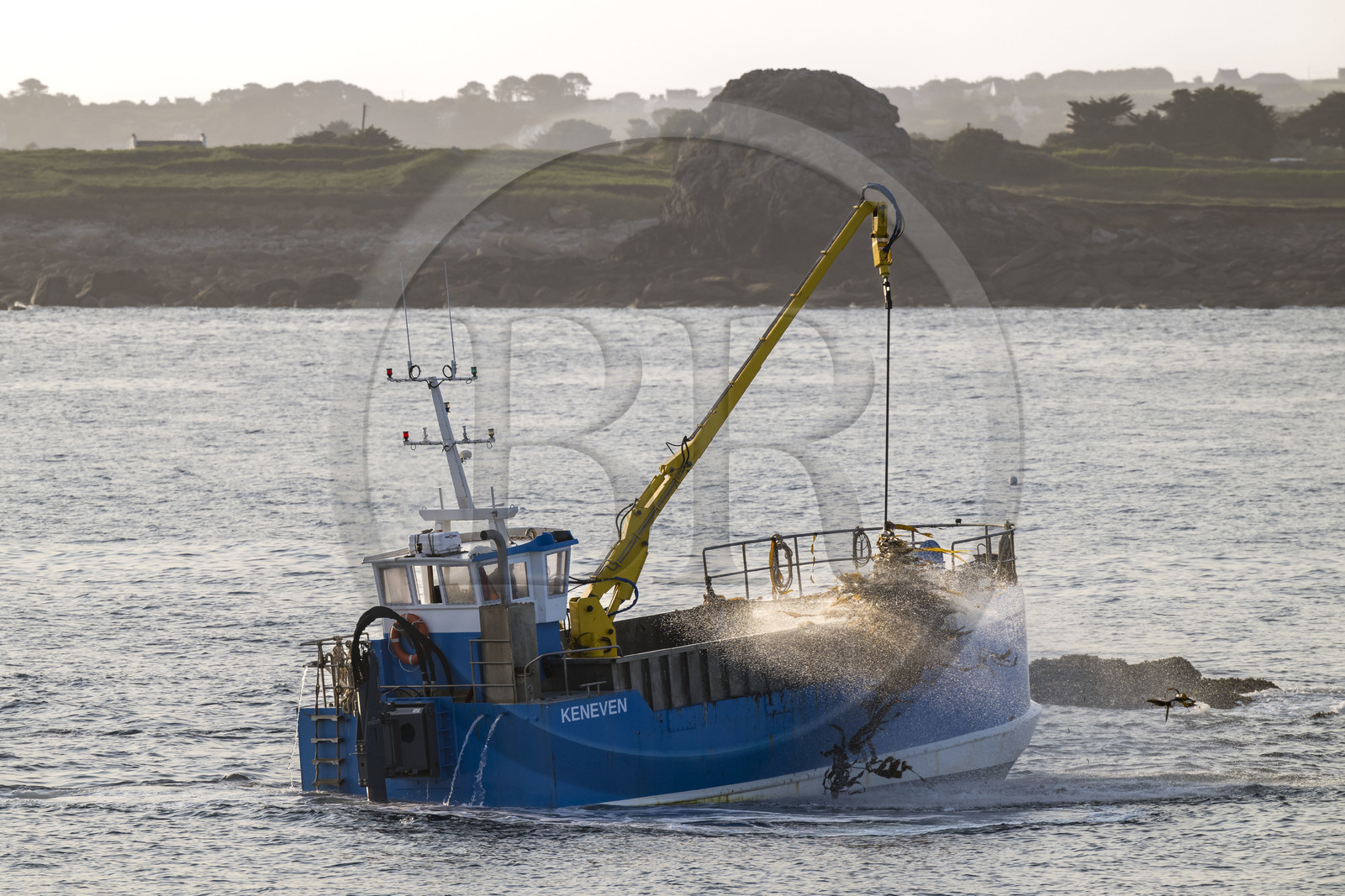 France, Finistère, Abers Country (Pays des Abers), Ile Vierge (Virgin Island) in the Lilia archipelago, seaweed boat using one of its two articulated mechanical arms ending in a scoubidou to harvest seaweed