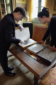 France, Aisne, Château-Thierry, Jean de La Fontaine Museum - city of Chateau-Thierry, the director of the museum pole Nicolas Rousseau and his deputy director Marie-Mileva Pavlovitch observing the La Fontaine's Fables book, illustrated edition (1867, in-folio) by Gustave Doré