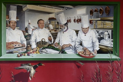 France, Rhone, Collonges au Mont d'Or, L'Auberge du Pont de Collonges Paul Bocuse Restaurant, painted wall portraying famous French chefs cook contemporary from Paul Bocuse