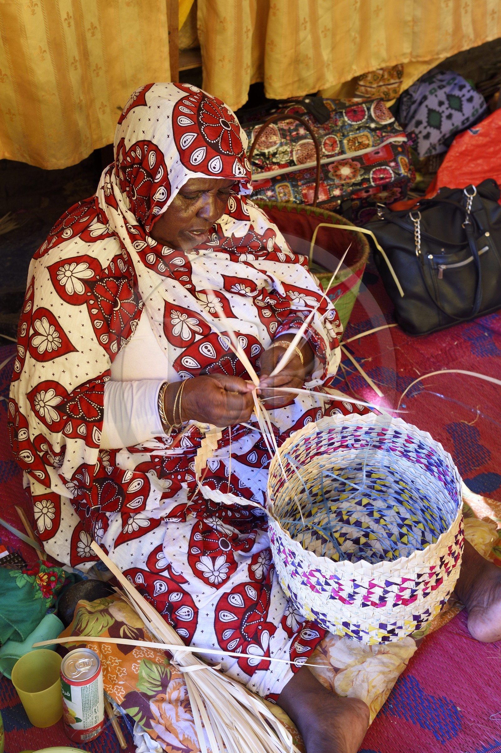 France, Mayotte island (French overseas department), Grande-Terre, Sada, Mahoran women weaving phoenix reclina wild (palm tree) fibers to make baskets at the cooperative