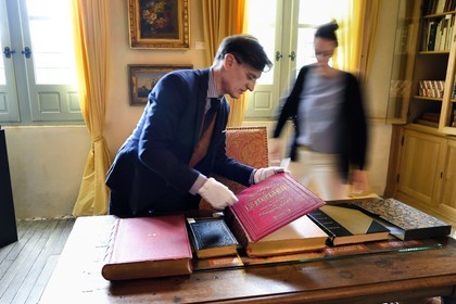 France, Aisne, Château-Thierry, Jean de La Fontaine Museum - city of Chateau-Thierry, the director of the museum pole Nicolas Rousseau and his deputy director Marie-Mileva Pavlovitch observing the La Fontaine's Fables book, illustrated edition (1867, in-folio) by Gustave Doré
