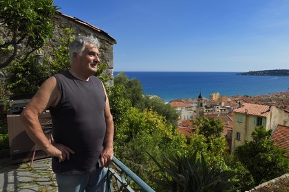 France, Alpes-Maritimes, Menton, old town, Germain Vernis observes the old town from his terrace
